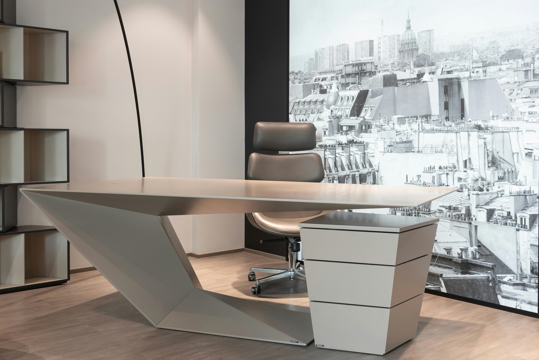 Modern office desk with angular design and leather chair